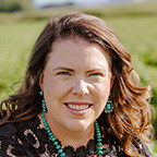 Jessica Groskopf, extension educator, is photographed in a field.