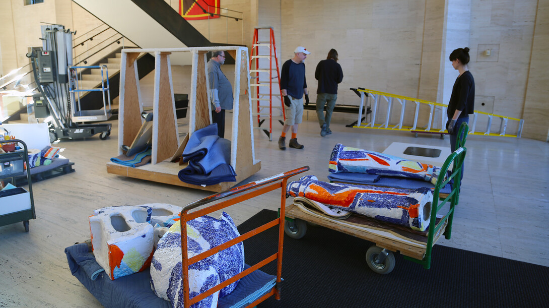 Sheldon exhibits staff start assembling "Handout Man" in the museum's Great Hall. The sculpture is made up of 13 different ceramic pieces bolted together.