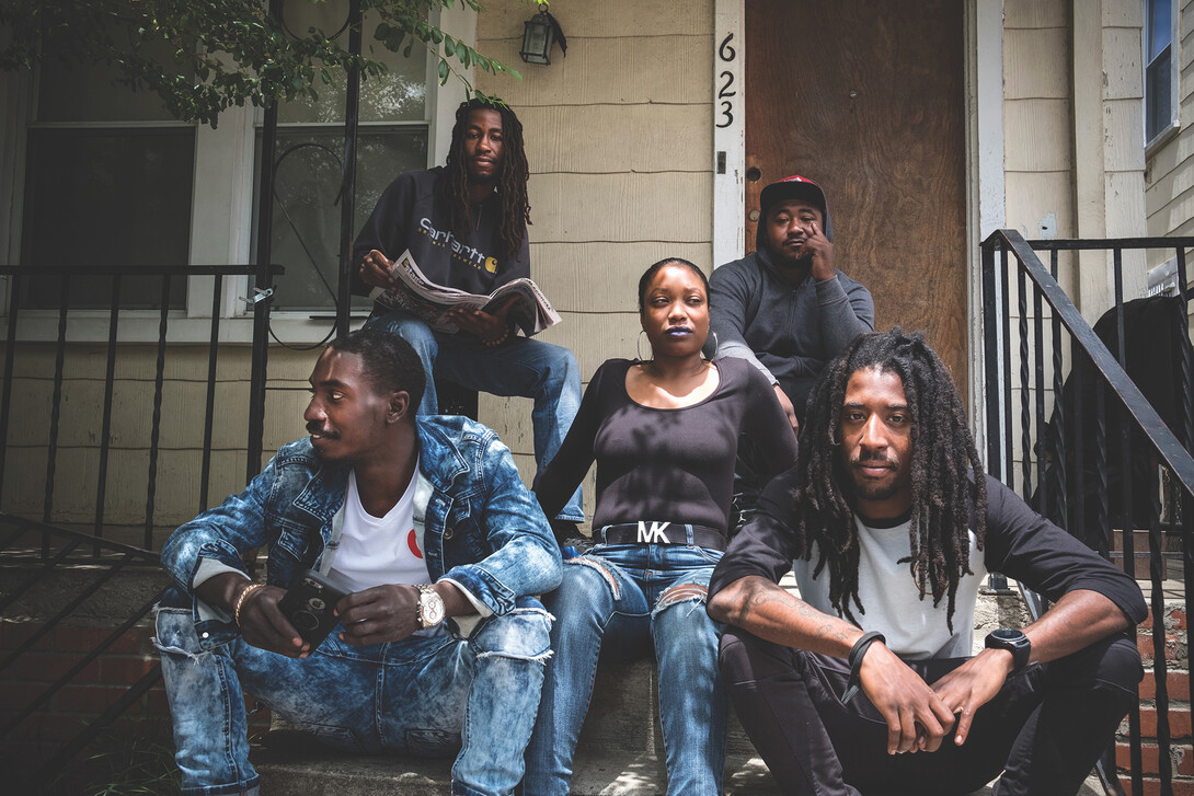 Neighbors sit on their Park View porch in Washington, D.C. Kessler said the families spend a lot of time together in the space, which has become a staple of Newton Place.