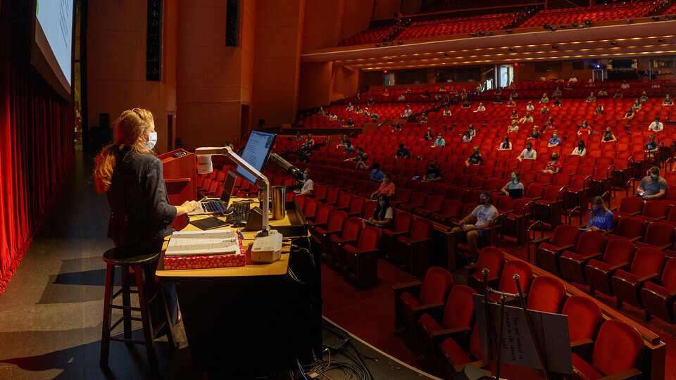 Trisha Vickrey (left) leads a chemistry lecture in the Lied Center for Performing Arts on Aug. 24. 