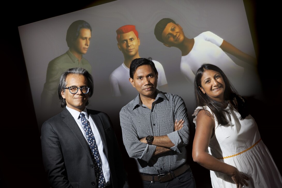 Bilal Khan, Mohammad Hasan and Neeta Kantamneni standing in front of a screen with their digital doppelgangers
