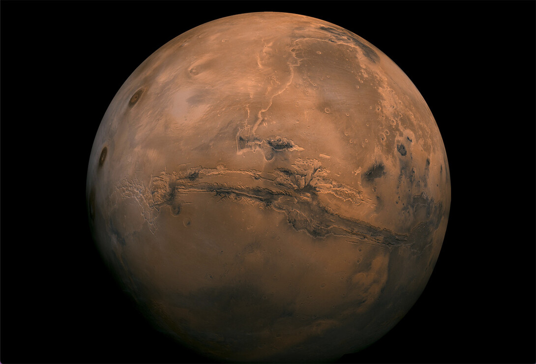 Mosaic of the Valles Marineris hemisphere of Mars projected into point perspective, a view similar to that which one would see from a spacecraft. The mosaic is composed of 102 Viking Orbiter images of Mars.