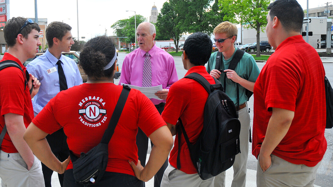 Patrick McBride reviews procedures with the New Student Enrollment parking team outside the 16th and R streets garage on June 6.