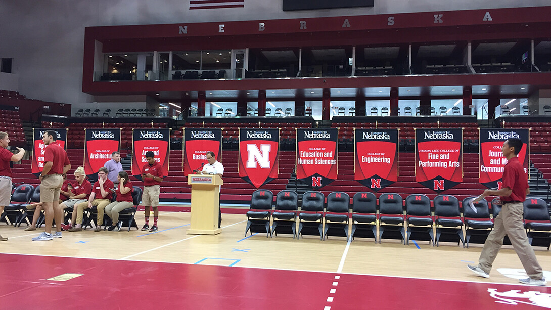 Corrie Svehla (left, in blue) helps make final preparations for New Student Convocation in 2017. Svehla, who helps senior administration with technology needs and special events, has worked at Nebraska for nearly 23 years.