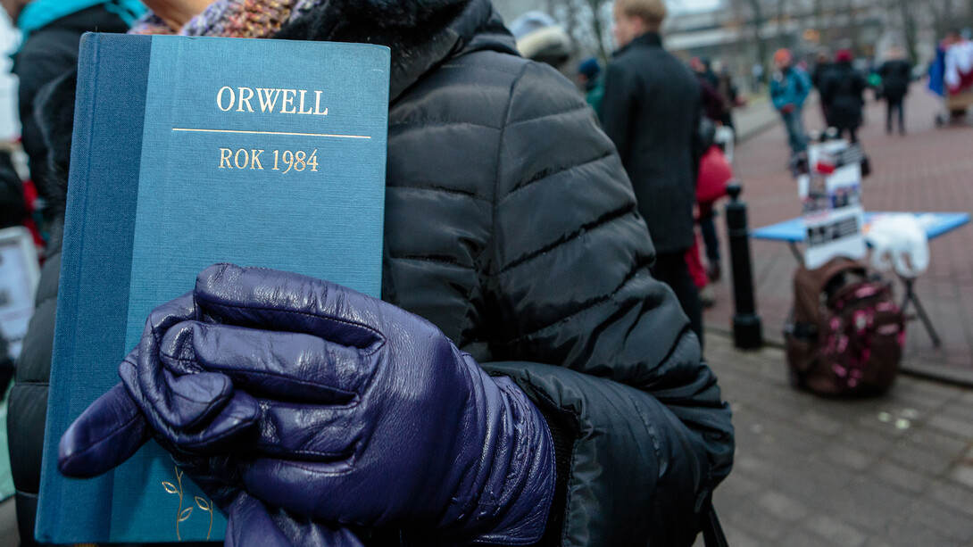 A protestor holds a copy of George Orwell's "1984" during a protest in front of the parliament building in Warsaw, Poland.
