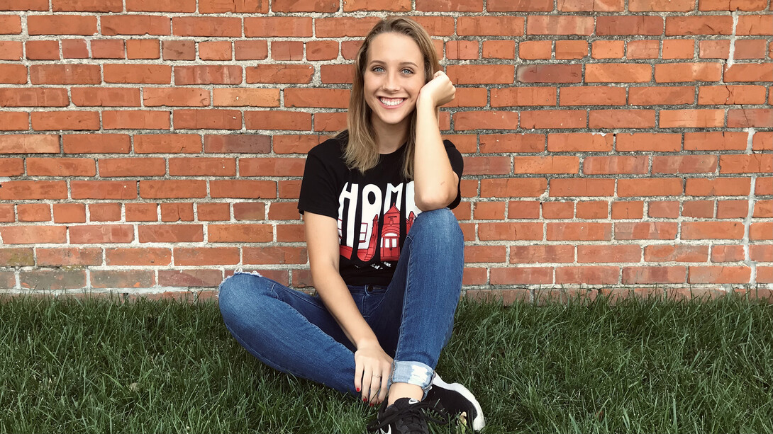 Elizabeth Pernicek is photographed in front of a brick wall.