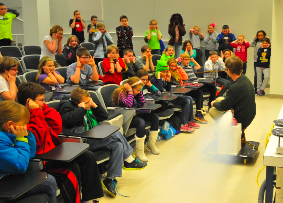 UNL's Cliff Bettis demonstrates how a sudden release of carbon dioxide propels a cart during his Feb. 1 Saturday Science lecture.