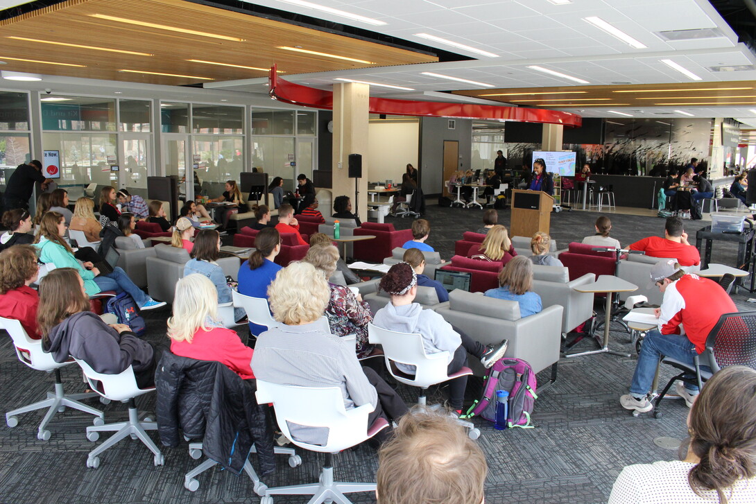 Adrienne Christian, graduate student in English and Art, reading poetry at Poetry Month event in 2017. 