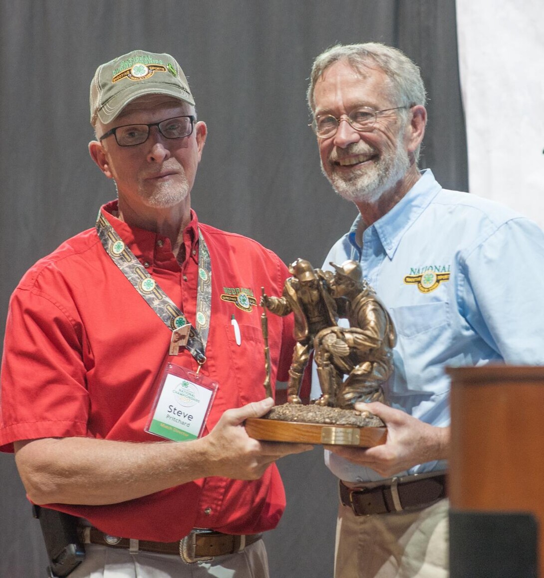 Nebraska’s Steve Pritchard (left) accepts a leadership award from Conrad Arnold, national 4-H shooting sports program coordinator.