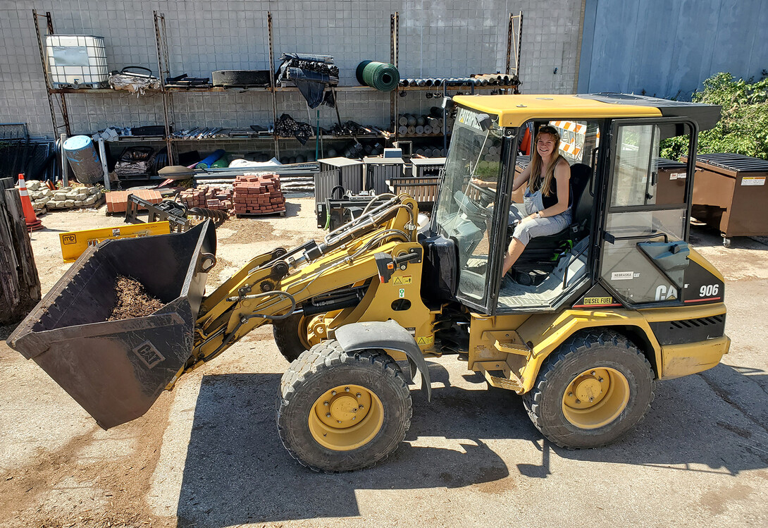 Amber Reinkordt behind the wheel of one of her favorite pieces of work machinery, a Caterpillar 906.