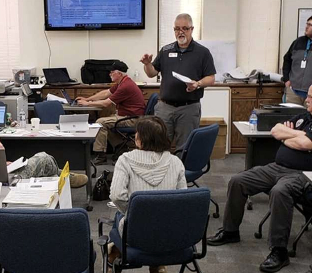 Mark Robertson leads a briefing as part of the flooding response in Fremont.