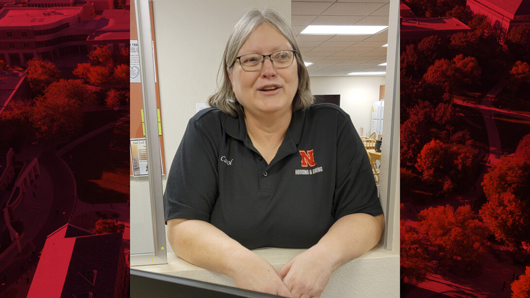 Photo of Carol Ruwe standing at a counter in Knoll Hall.