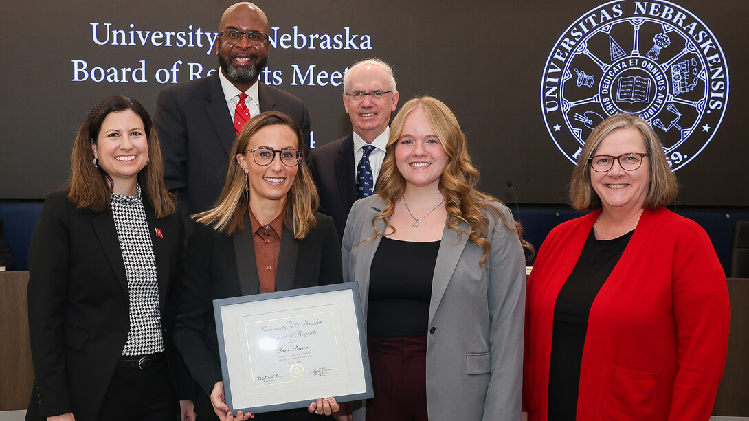 Sara Quinn holds her award as she stands with other university officials after receiving the Kudos honor during the Board of Regents meeting in Kearney on Oct. 4.