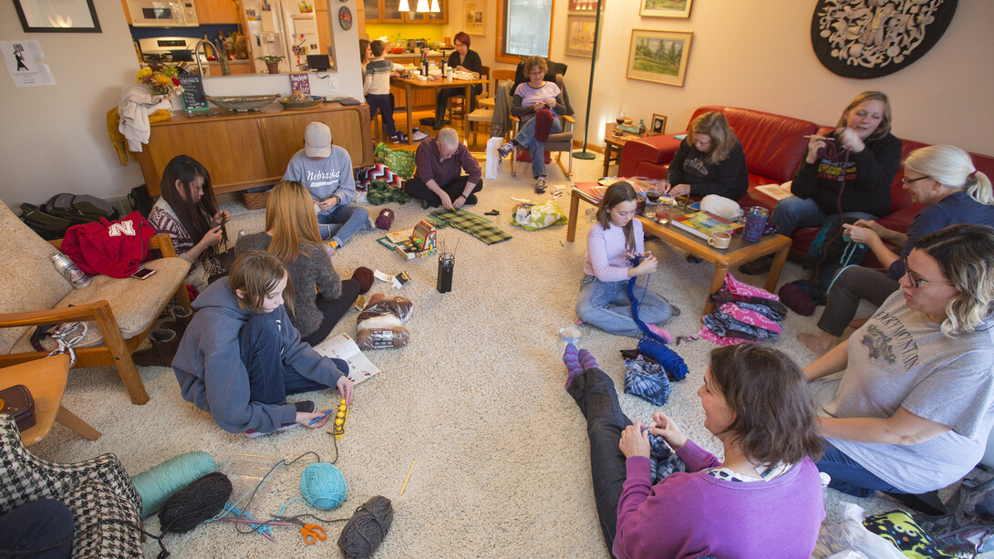 "Scarves for Kids" volunteers work in Jo Ann Emerson's living room and kitchen. The group is making scarves for students at McPhee Elementary in Lincoln.