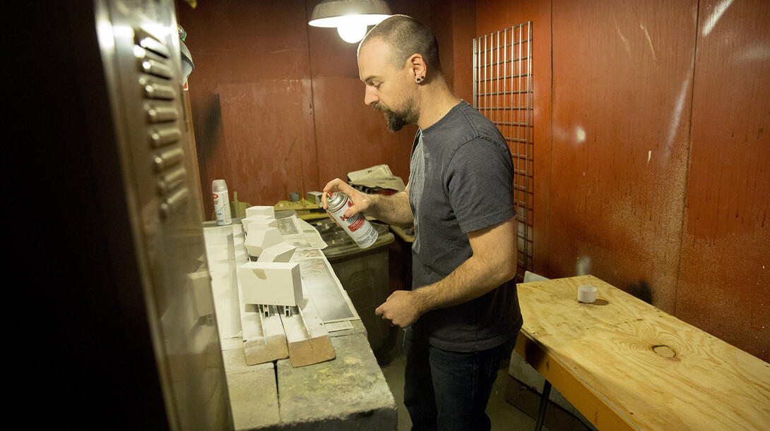 UNL's West Schomer paints concrete shapes that will be used for a crystal display in the University of Nebraska State Museum. Schomer will donate a kidney to Dustin Curry, his longtime friend and brother-in-law, on Nov. 19.