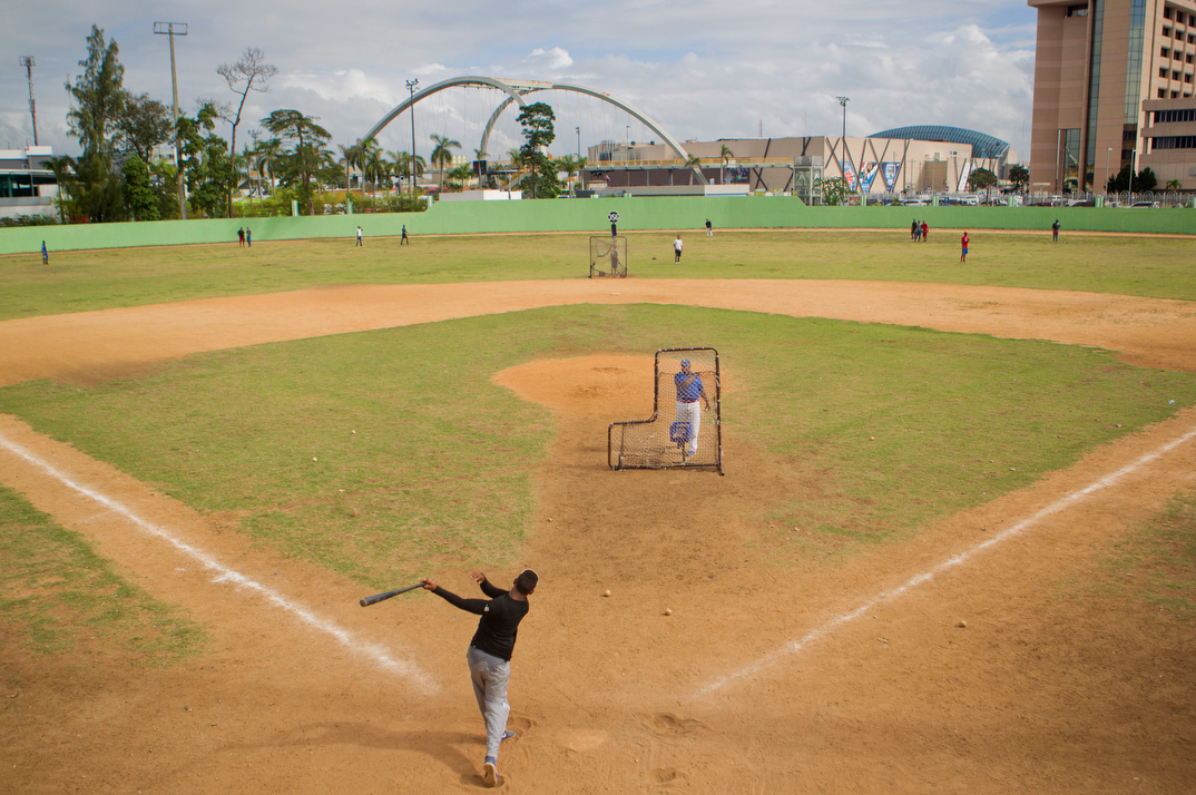 A shortstop takes batting practice at the Centro Olimpico baseball field in Santo Domingo.
