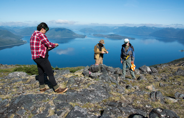 Researchers (from left) Elizabeth Howard, Mike Chondoronek and Ralph Hartley record initial observations of an Alaskan alpine cairn.