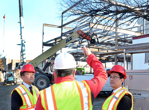 Rik Barrera (center), assistant dean for business, leads (left) Yutaka Takahashi and Yuta Yazawa, both of Senshu University, on a tour of UNL's new College of Business Administration Building.