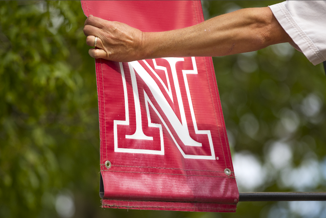 Out with the old: The Academic N is removed from an R Street lamp post on June 28.