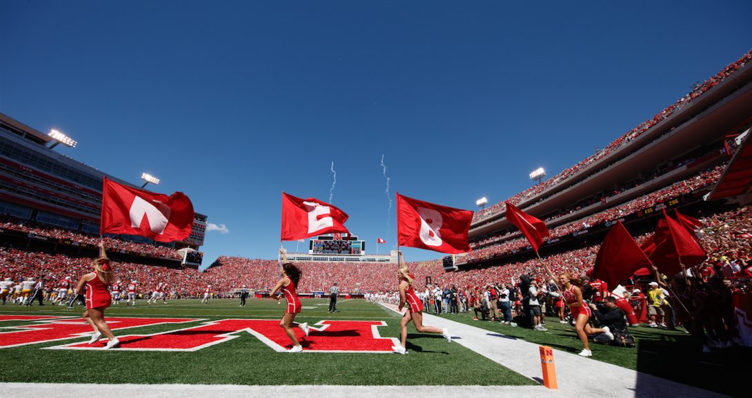 Spirit squad members charge onto the field during Sept. 10's Nebraska-Wyoming game. 