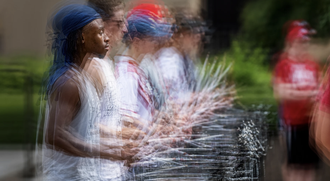 The sticks are flying in this multiple exposure image of Tamario Brooks during an evening practice of the snare line.