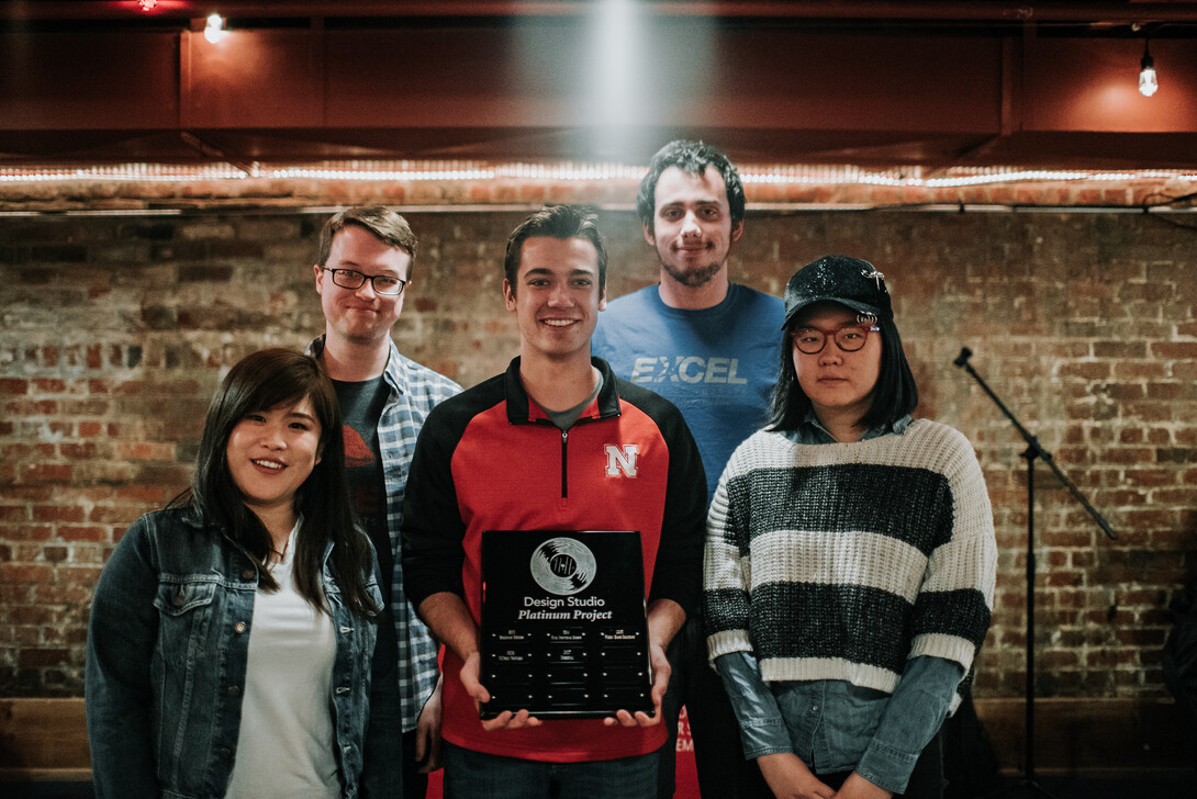 Design team Sensi-Plate accepting its platinum award earned during the 2018 Senior Design/Design Studio Showcase.