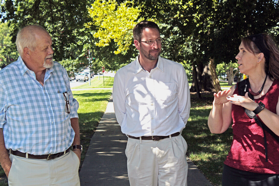 Andries Jordaan (left) and Janse Robie, both of disaster management agencies in South Africa, talk with NDMC climatologist Deborah Bathke during a recent visit to learn about the center's available tools.