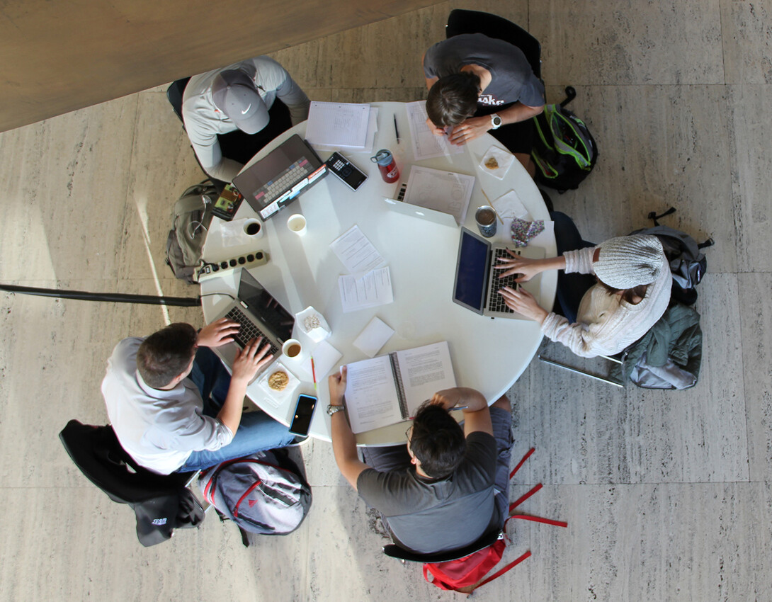 Students study at a table in Sheldon's Great Hall.