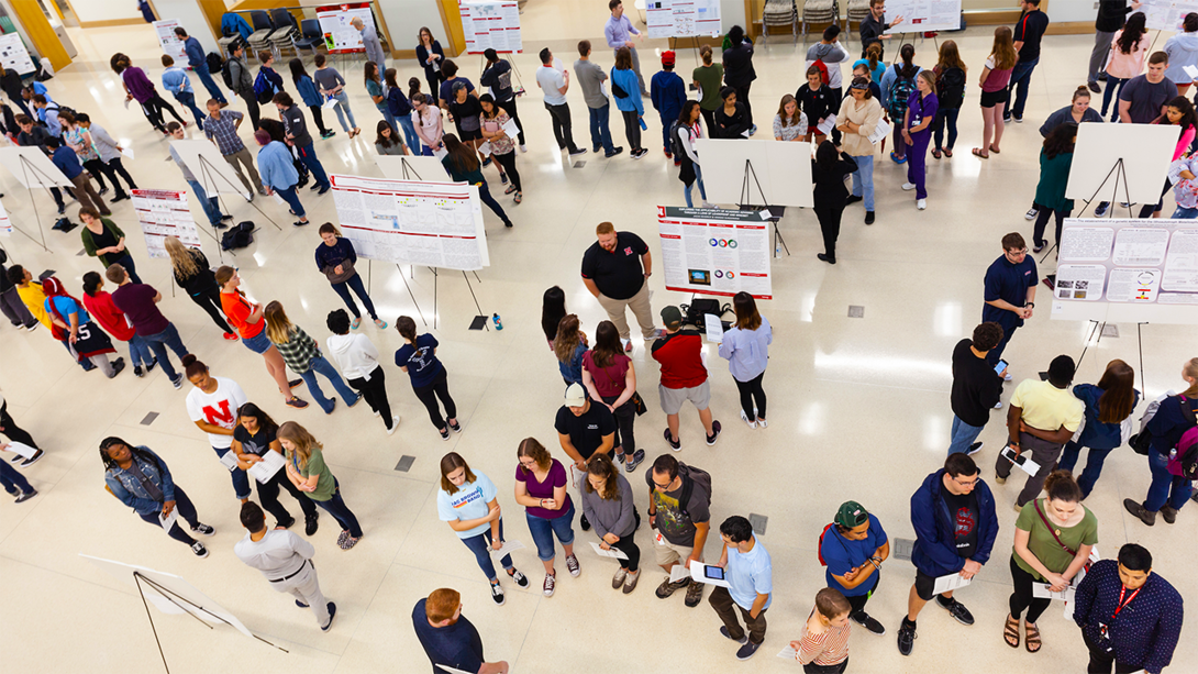 Nebraska students take part in a poster session in Howard L. Hawks Hall. More than 100 100 undergraduates from across the United States and Puerto Rico are getting a 10-week preview of graduate programs at Nebraska.
