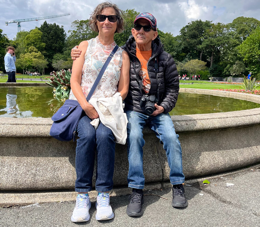Julia and David Torquati sit, arm in arm, on a fountain. Julia is professor of Child, Youth and Family Studies.