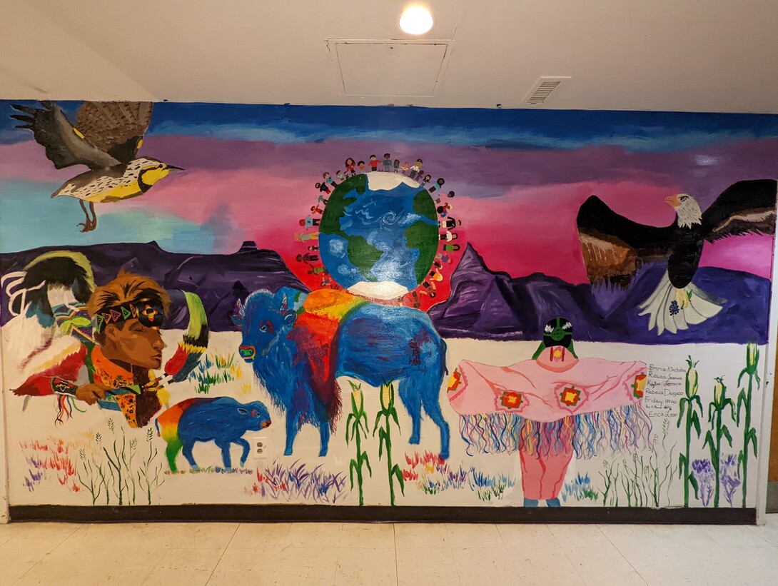 A 15-foot-wide colorful, Native-themed mural created by students from UNL’s Regular Upward Bound and Upward Bound Math-Science programs now decorates a wall of the Lincoln Indian Center at 1100 Military Rd in Lincoln, Nebraska. 