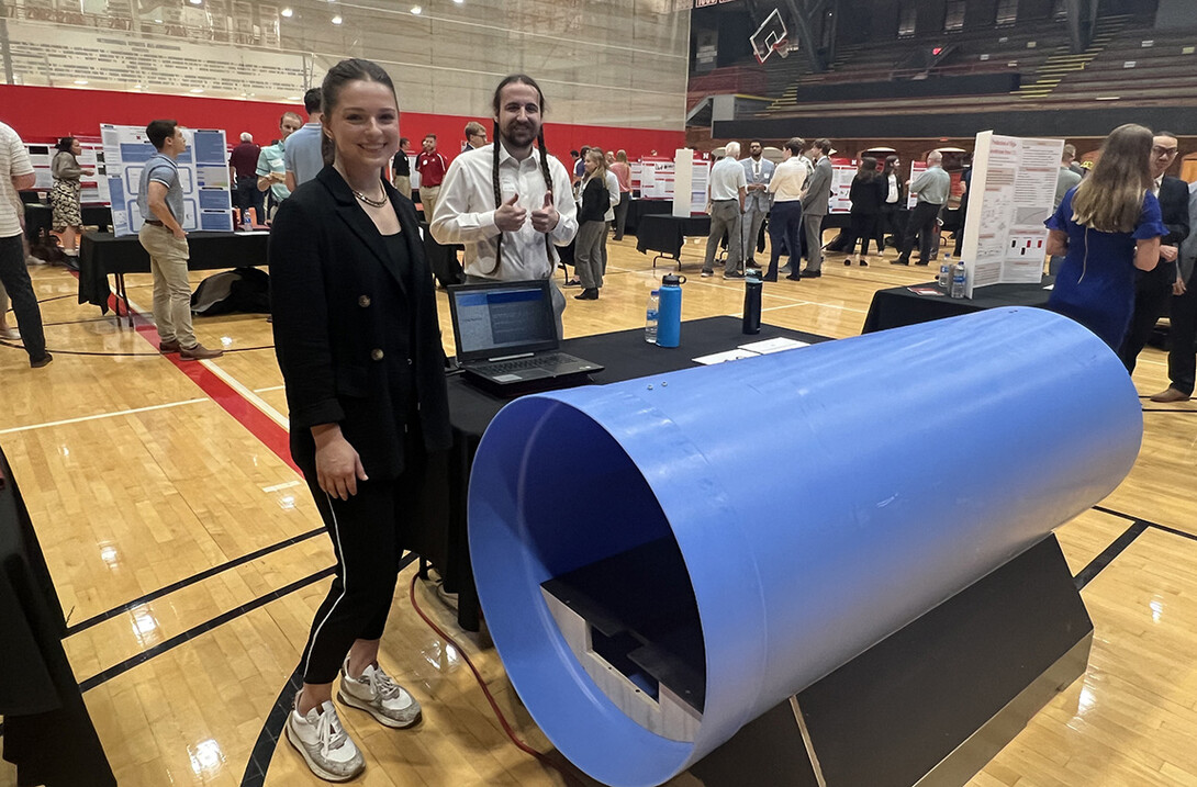 Capstone team members Summer McGrew and Evan Harner display a 6-foot section of the tunnel they designed to replicate the experiences of flight crew members aboard a B-36 bomber.