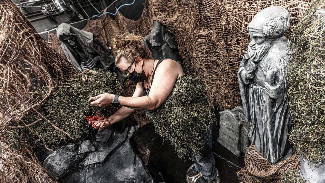 Woman working with haunted house decorations