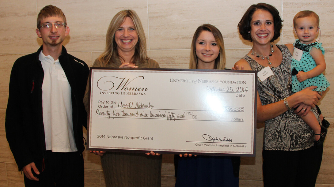 Stacie Ray, director of HearU Nebraska and associate professor of practice in audiology (second from left), accepts the grant award of $75,950 from Women Investing in Nebraska and is joined by her son, Brandon Ray (far left), and HearU Nebraska clients Hannah Lionberger (third from left), and Kelly Rausch (second from right) and her daughter Evie Rausch.