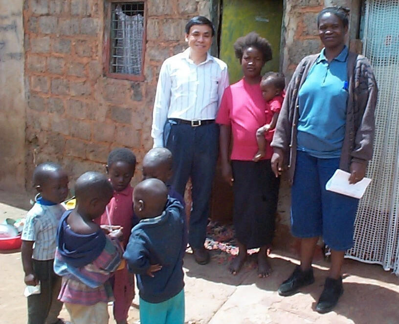 Nebraska's Charles Wood stands with research clients in Zambia.