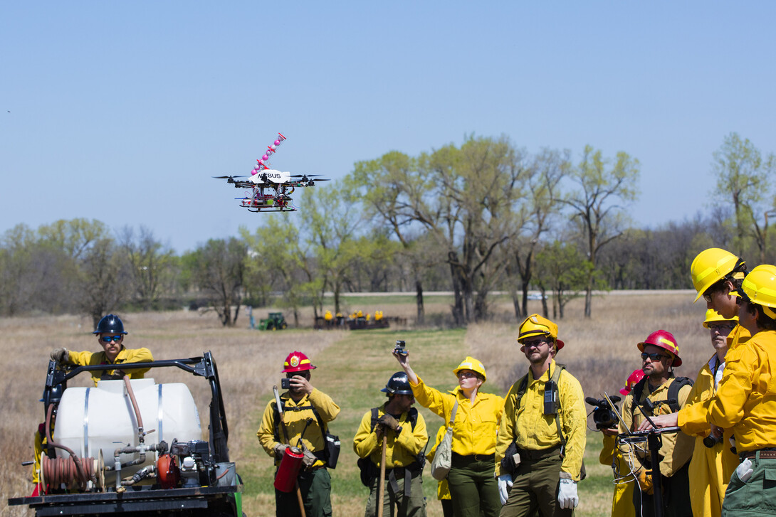 The drone takes off on its fifth flight of the test surrounded by the UNL drone team, media and firefighters.