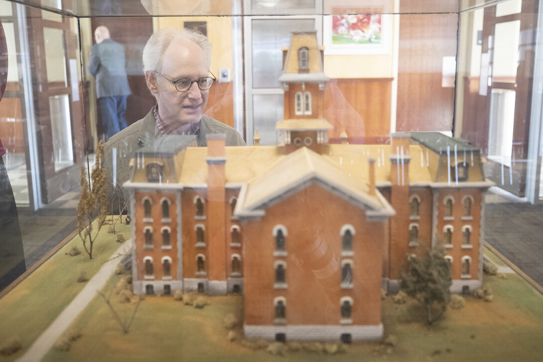 Mark Griep, associate professor of chemistry, examines a model of University Hall. The model, used by NET to create a virtual reality tour of the university’s first building, was presented as a gift of the class of 1897.