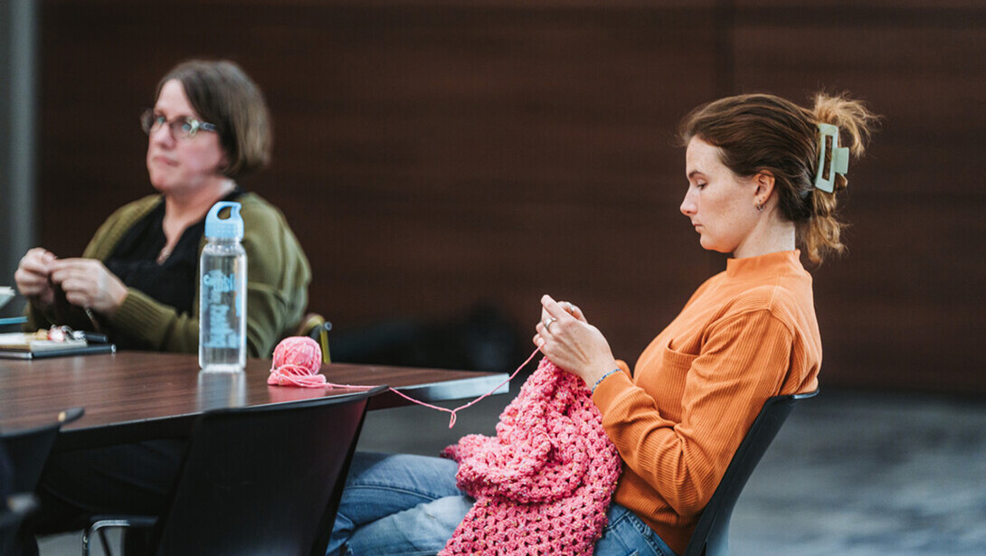 Members of an NCLUDE knitters group work on their projects.