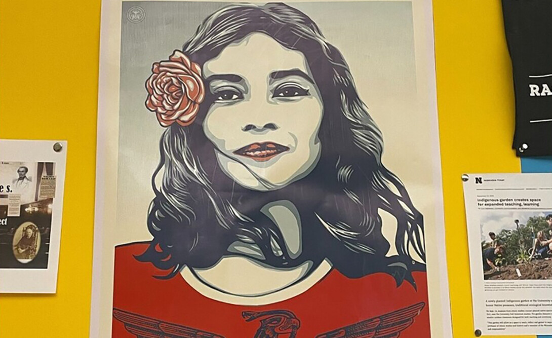 Artwork showing a girl with a flower in her hair is displayed on a bulletin board.