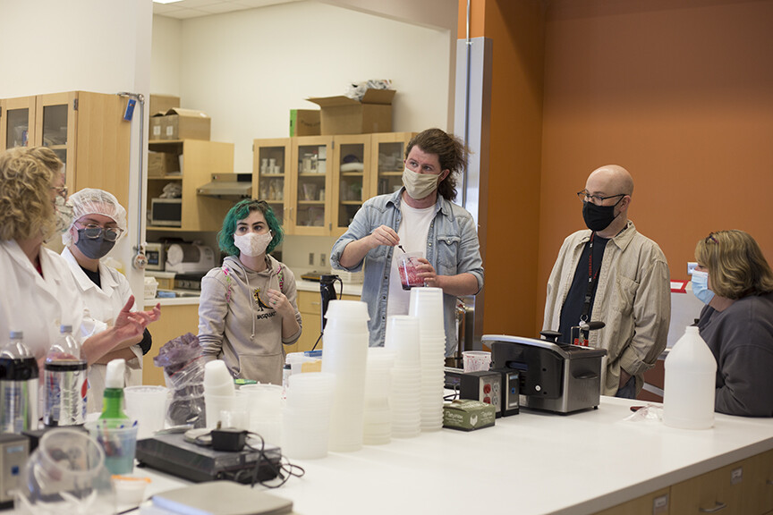 “Dracula: Mina’s Quest.” Right: (Left to right) Bethany Jackson, Zoe Kraus, Camille Lerner, Nathan Alexander, Jamie Bullins and Julie Reiling work on the perfect formula for the blood used in “Dracula: Mina’s Quest” at the Food Innovation Center. Photo by