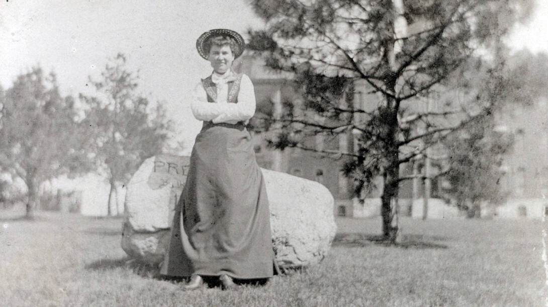 Willa Cather poses in front of an engraved boulder on the University of Nebraska campus in the early 1890s. Scholars from around the world will be at UNL June 8-12 to attend the 15th International Cather Seminar.