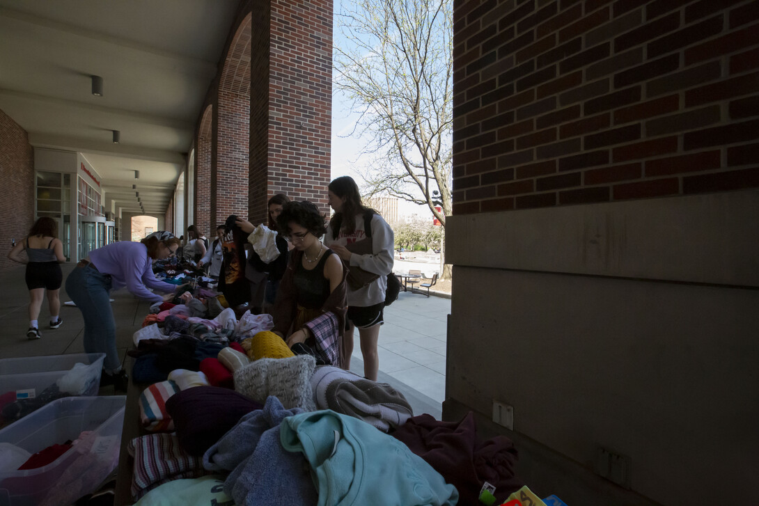 people going through clothing at the clothing swap