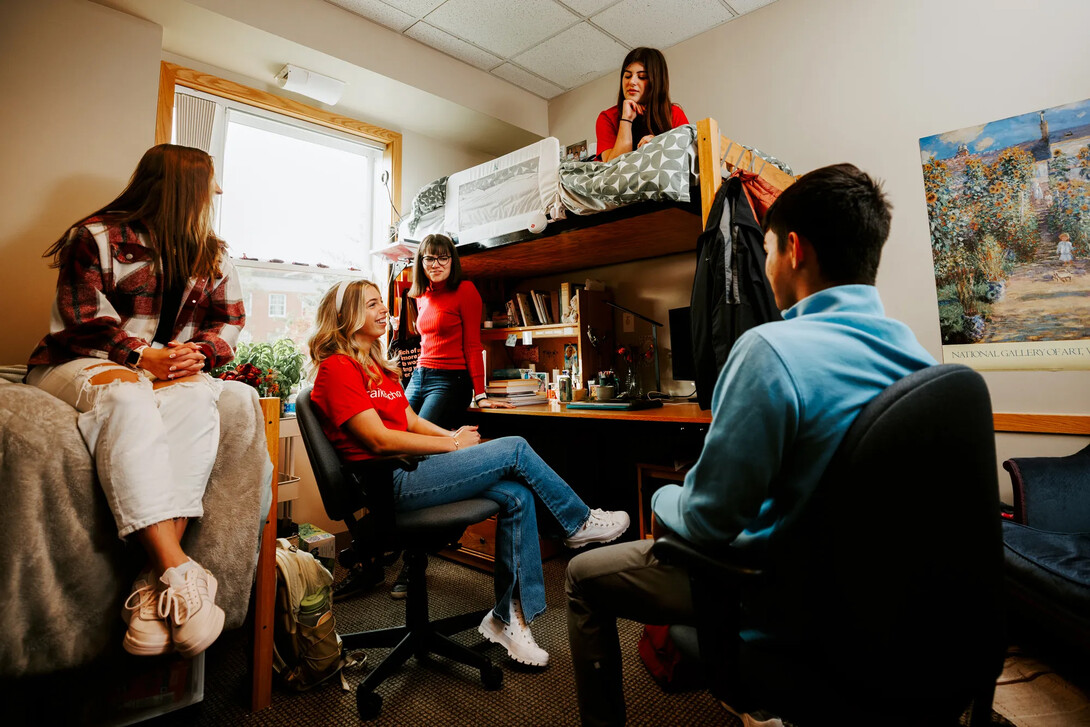 Students hanging out in a residence hall room.