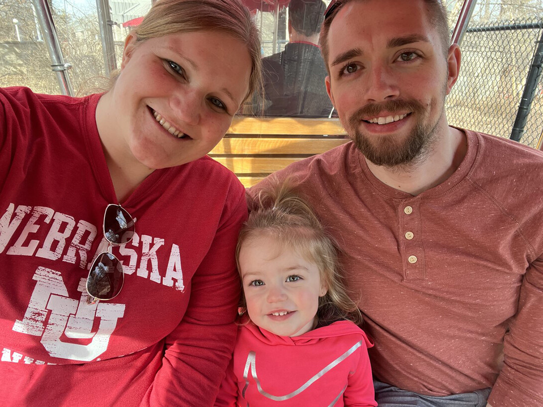 Tiffany Groteluschen (from left), her daughter, Jade, and husband, Beau pause for a photo on the train at the Lincoln Children's Zoo.