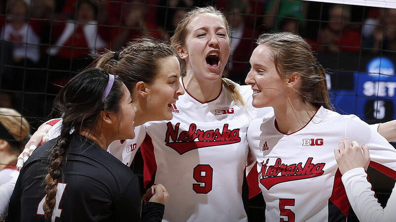 Husker volleyball players celebrate during a match. UNL faculty and staff have until June 12 to submit applications to purchase season tickets for the Cornhusker volleyball team's 2015 season.