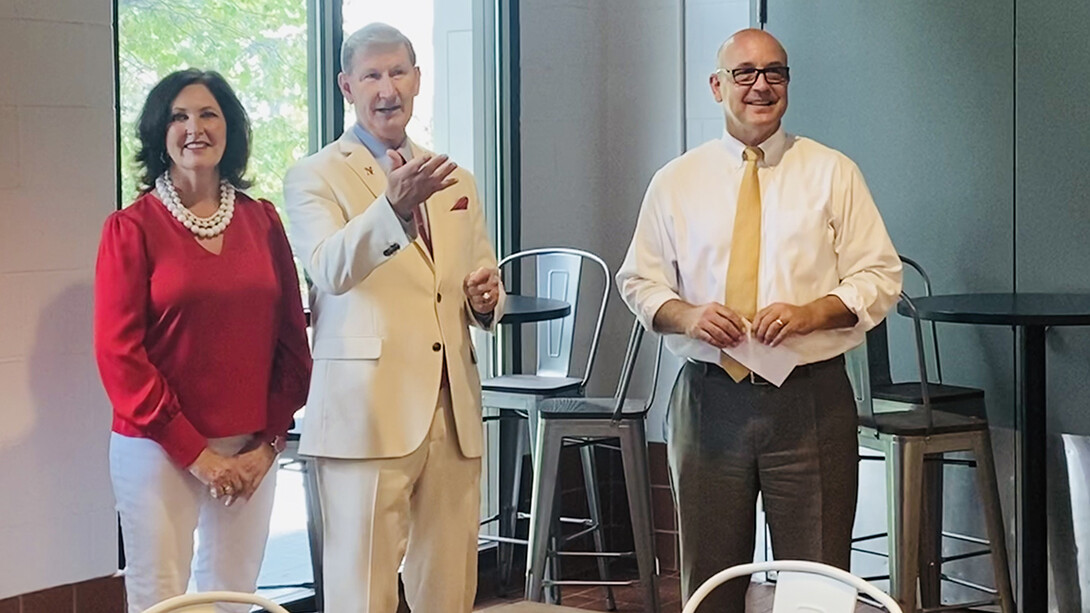 Lynda Carter, Ted Carter and Mike Boehm stand in front of a window in the Dairy Store on East Campus. They were attending an ice cream social that revealed a new flavor honoring Carter, the NU system president.