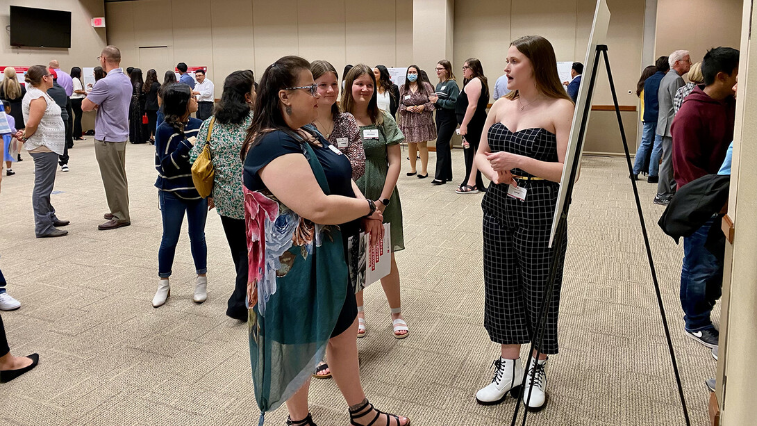 The NCPA celebration included a poster session with graduates discussing their work.