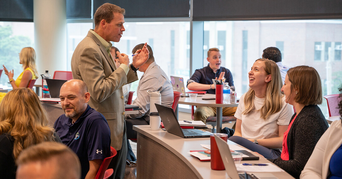 Online MBA students came to campus at the University of Nebraska-Lincoln to learn more about adaptive leadership. Part of a graduate course taught by Jake Messersmith (center), associate professor of management, they met with peers to create leadership plans to tackle organizational problems.