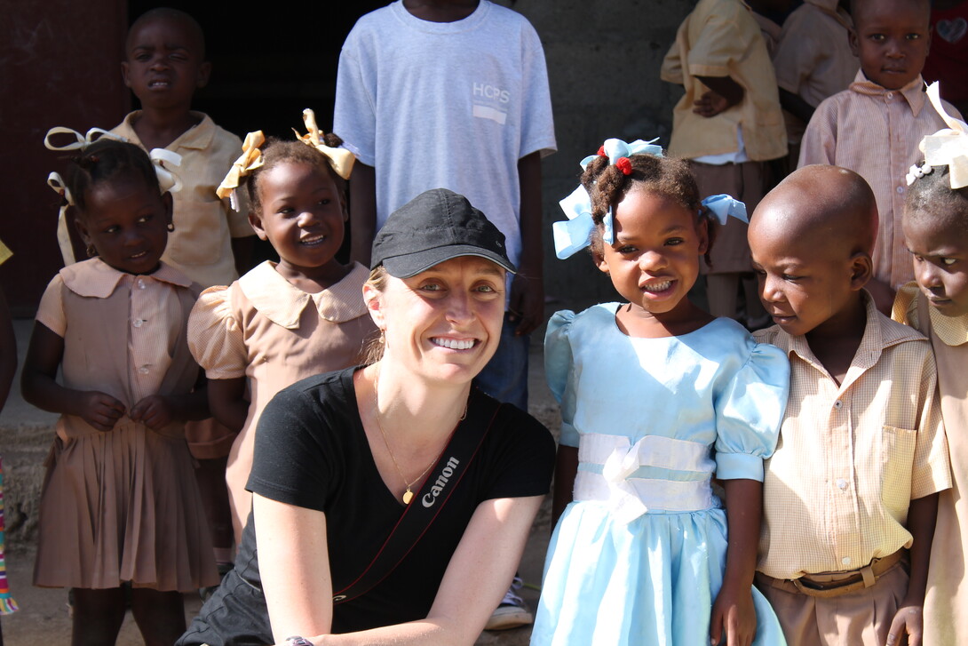UNL alumna Alaine Knipes poses with schoolchildren during a 2014 trip to Haiti. As part of the Centers for Disease Control and Prevention, Knipes worked to help eliminate a mosquito-borne infection that has afflicted millions throughout the country.