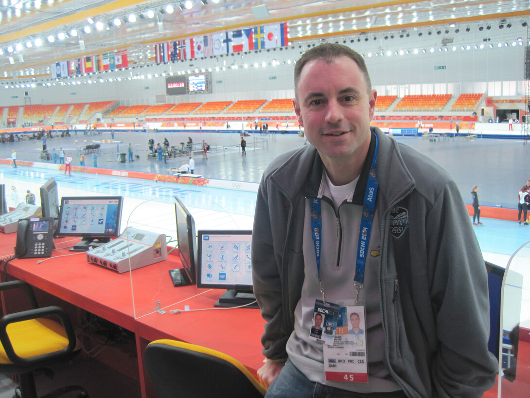 UNL alumnus Kevin Kugler sits in the Adler Arena Skating Center prior to announcing long track speed skating the 22nd Winter Olympics in Sochi, Russia. This is the fourth Olympic games Kugler has worked.